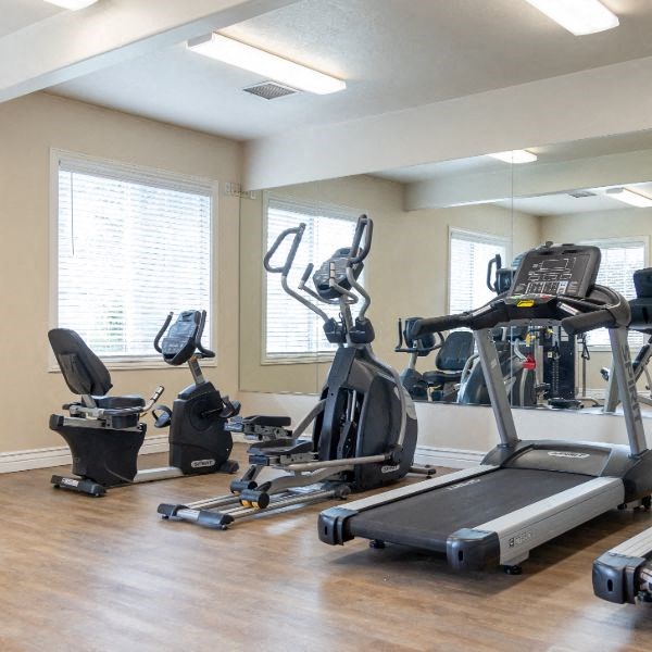 a gym with various exercise equipment in it