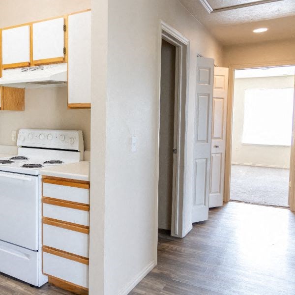 an empty kitchen with a stove and a door