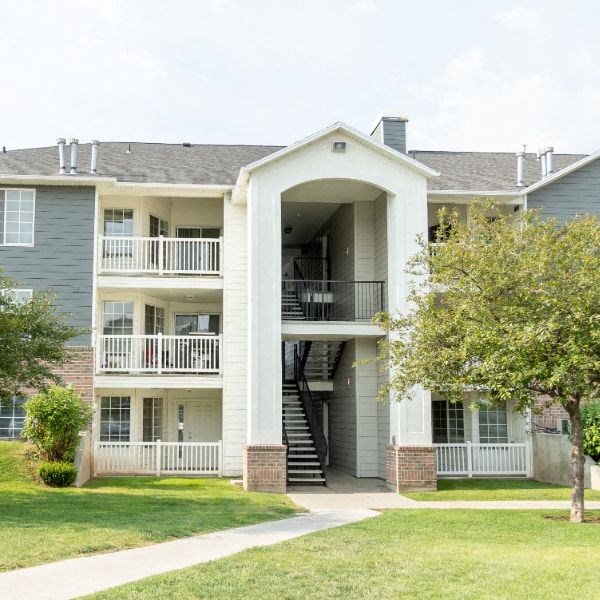the exterior of an apartment building with a staircase