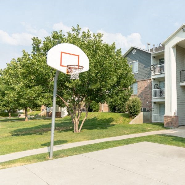 a basketball hoop in front of an apartment building