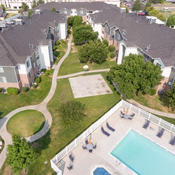 an aerial view of an apartment complex with a swimming pool