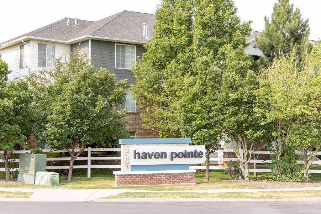 a sign for haven pointe in front of a house