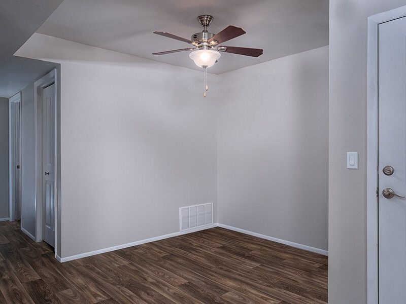 A room with a ceiling fan and a door.at Creekview, Midvale, 84047