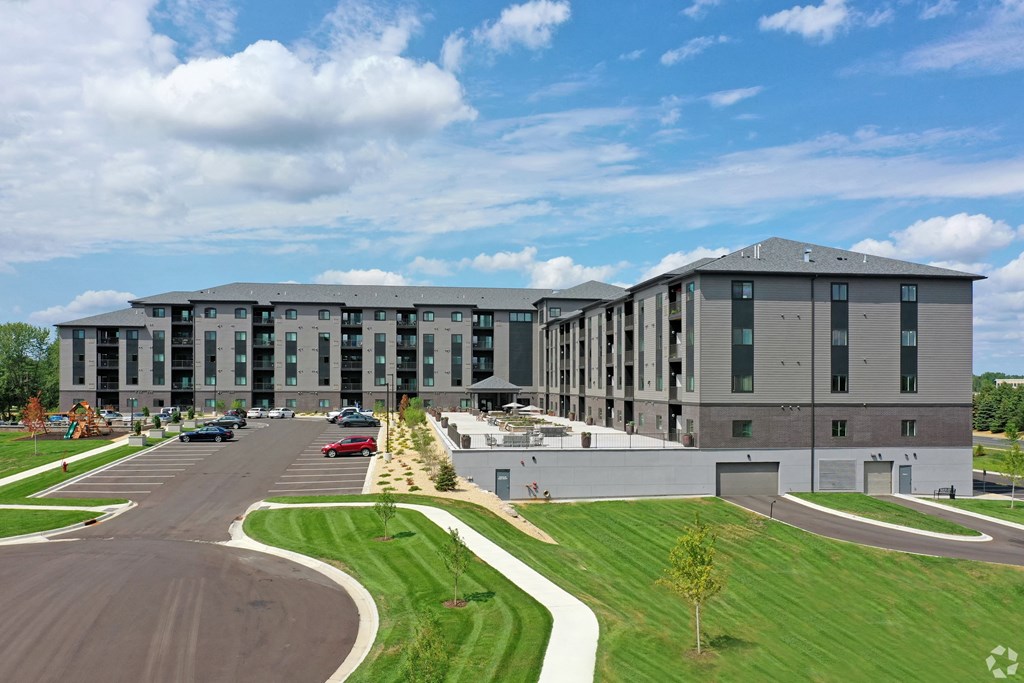 an aerial view of a large apartment building with a parking lot