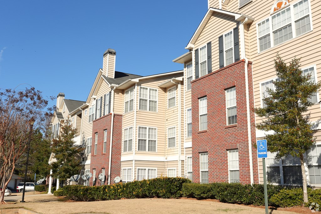 a brick apartment building with a blue sky in the background