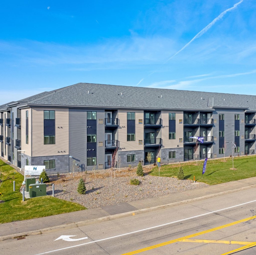 an apartment building on the side of a road