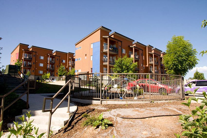 an apartment building with cars parked in front of it