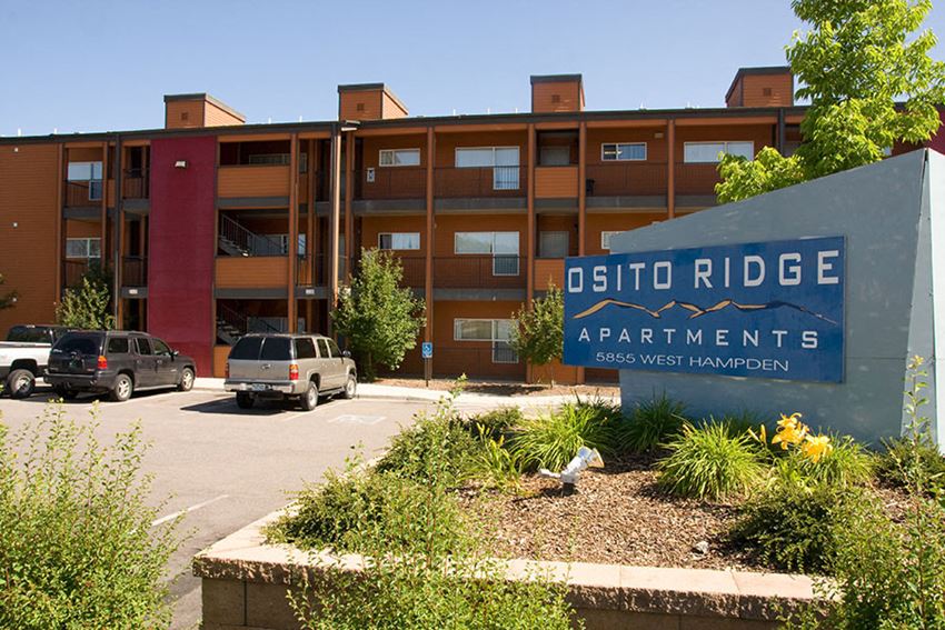 a sign for otto ridge apartments in front of a parking lot