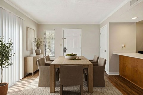 A dining room with a table and chairs.