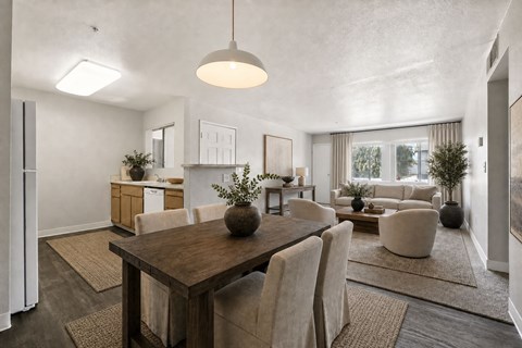 A modern dining room with a wooden table and chairs.