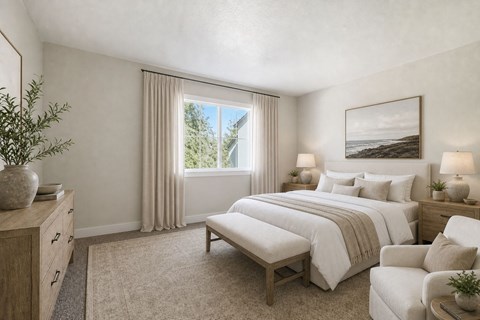 A bedroom with a large bed and a window with curtains.