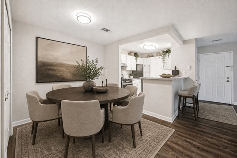 Dining area with round table and upholstered chairs at Northview Park Apartments, Sterling Heights, MI