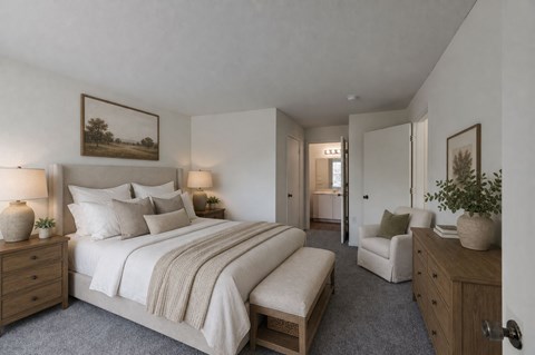 A bedroom with a large bed, a chair, and a painting on the wall.