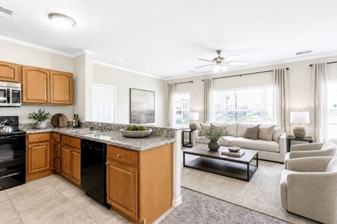 A kitchen with wooden cabinets and a black dishwasher.