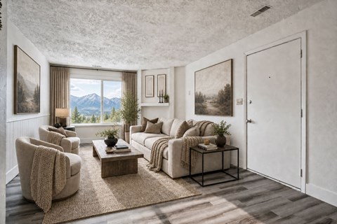 A living room with a large window overlooking a mountain range at The Morgan Apartments, Layton, UT, 84041