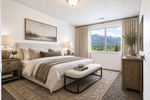 A bedroom with a large bed and a painting on the wall.