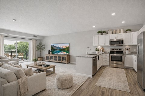 A modern kitchen with a large island and a painting on the wall.