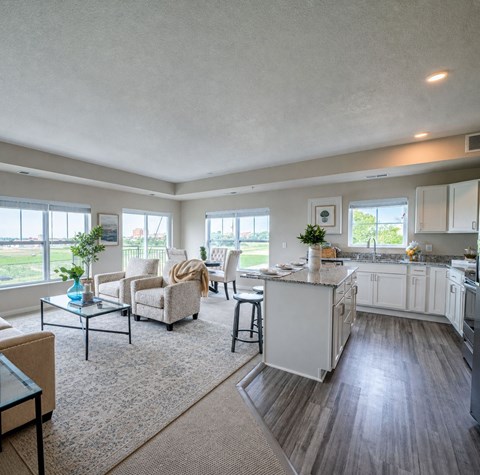 A well-lit, spacious kitchen and living room with a dining area.