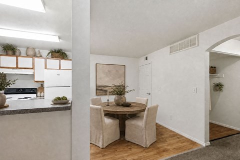 A dining area with a table and chairs.