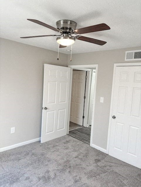 A room with a ceiling fan and two doors.