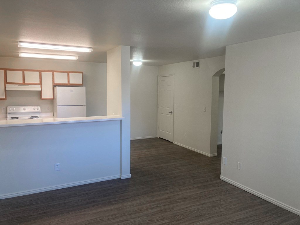 a kitchen and living room of an empty apartment