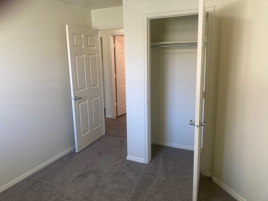 a bedroom with a closet and an open door