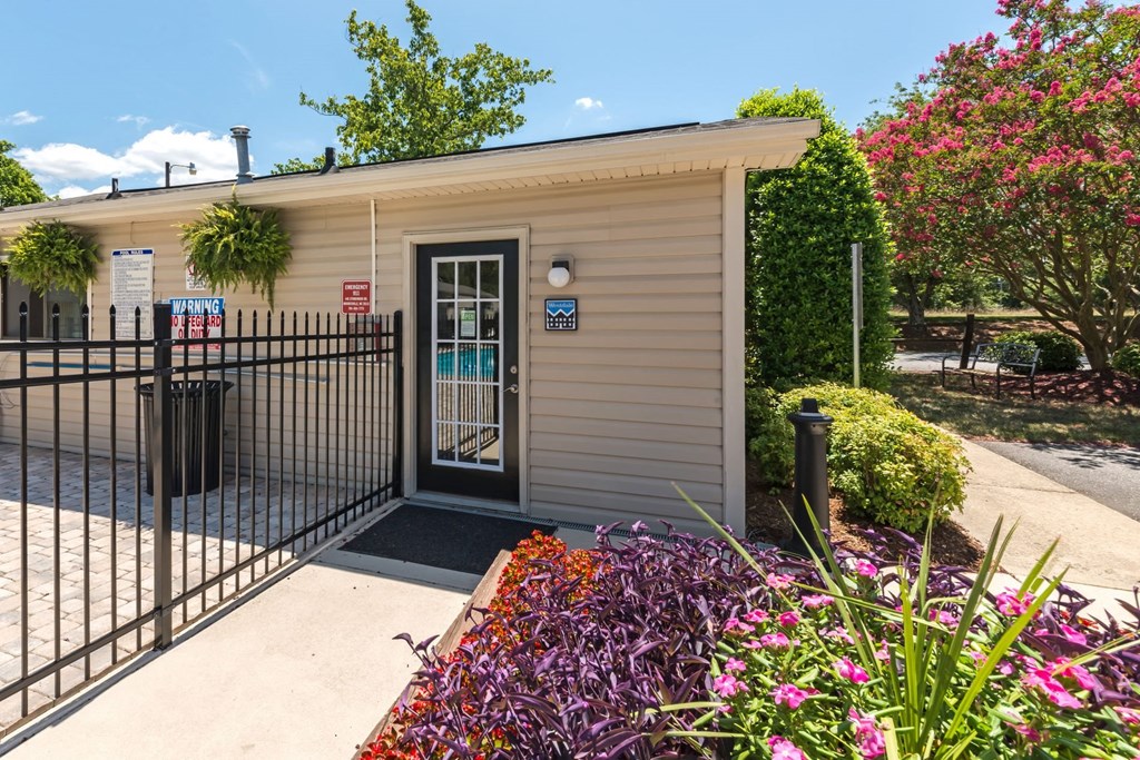the front of a building with a black fence and gate