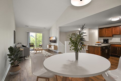 A white table with a plant on it in the middle of a room.