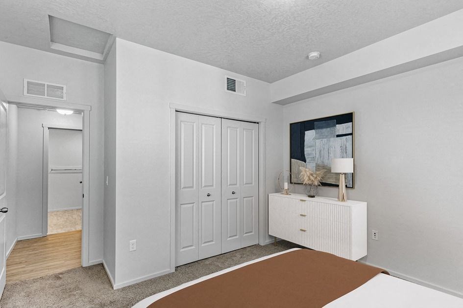 a bedroom with a bed and a dresser