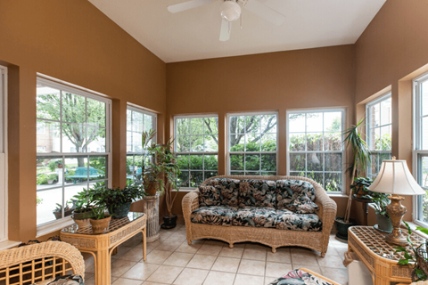 a sun room with a couch and windows