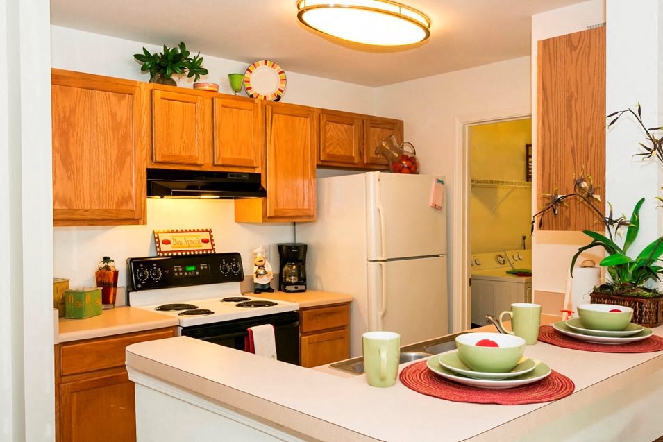 a kitchen with white appliances and wooden cabinets