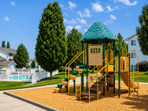 A playground with a green roof and yellow stairs.
