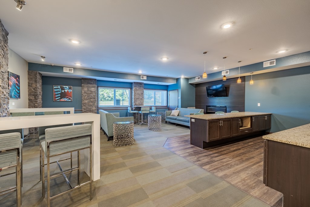 a living room and dining area with a couch and a tv