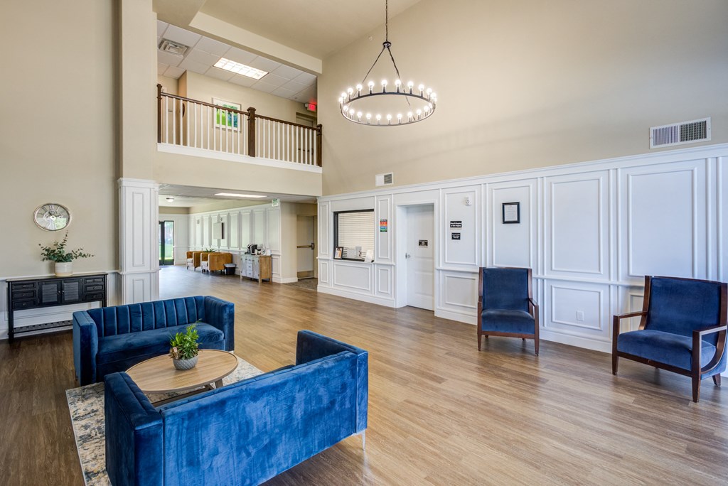 A large blue couch sits in the middle of a spacious living room.