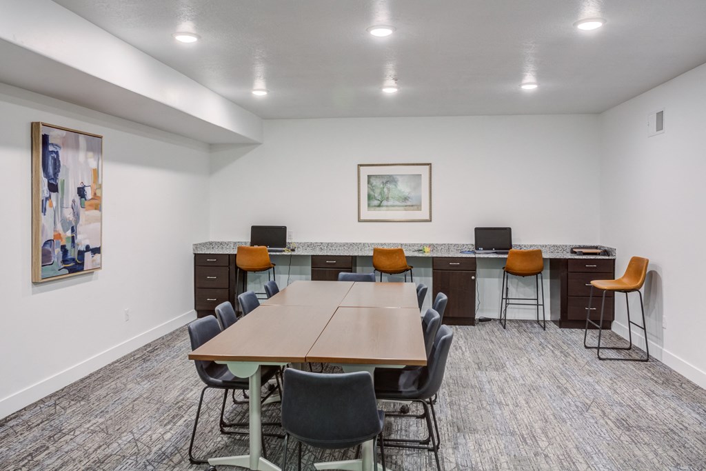 A conference room with a long table and chairs.