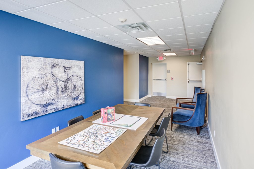 A conference room with a table, chairs, and a bicycle drawing on the wall.