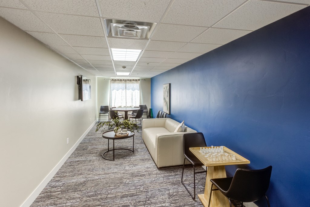 A room with a blue wall and a white couch.