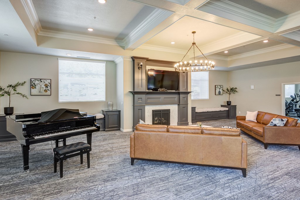 A living room with a piano, a fireplace, and a couch.