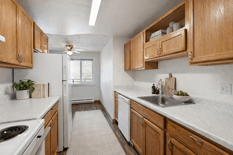A kitchen with wooden cabinets and a white refrigerator.