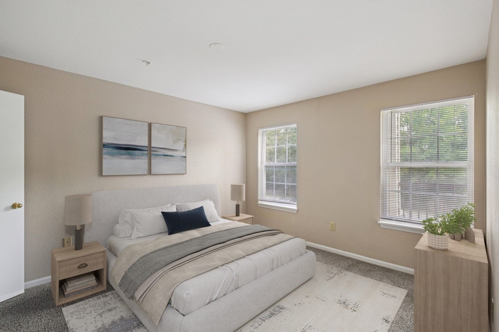 A bedroom with a large bed and a painting on the wall.