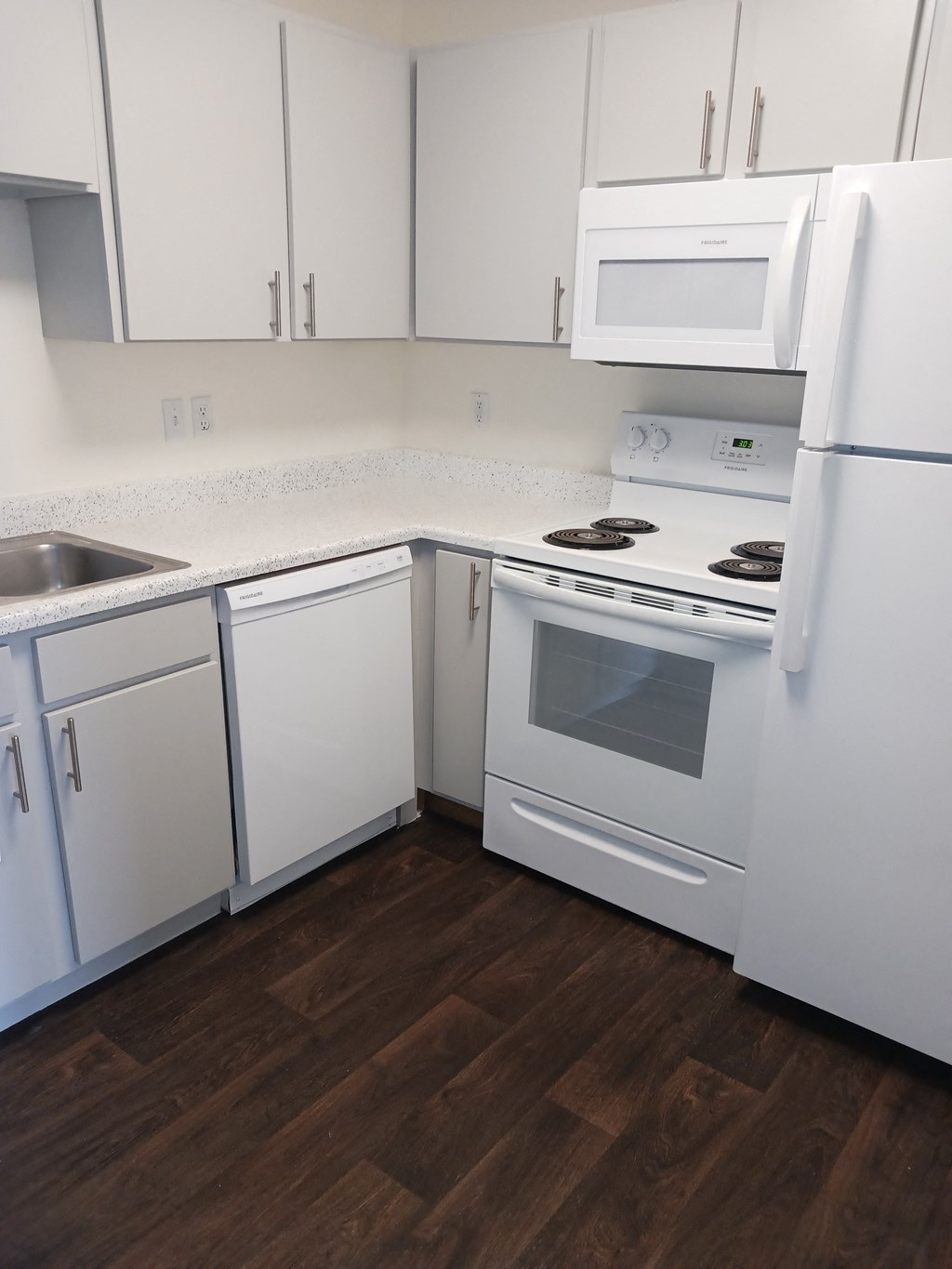 a kitchen with white appliances and white cabinets