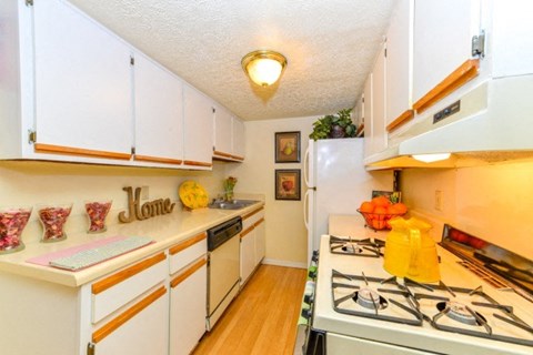 a kitchen with white cabinets and a stove top oven
