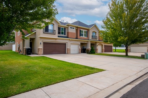 Two-story townhomes with a garage and a driveway.
