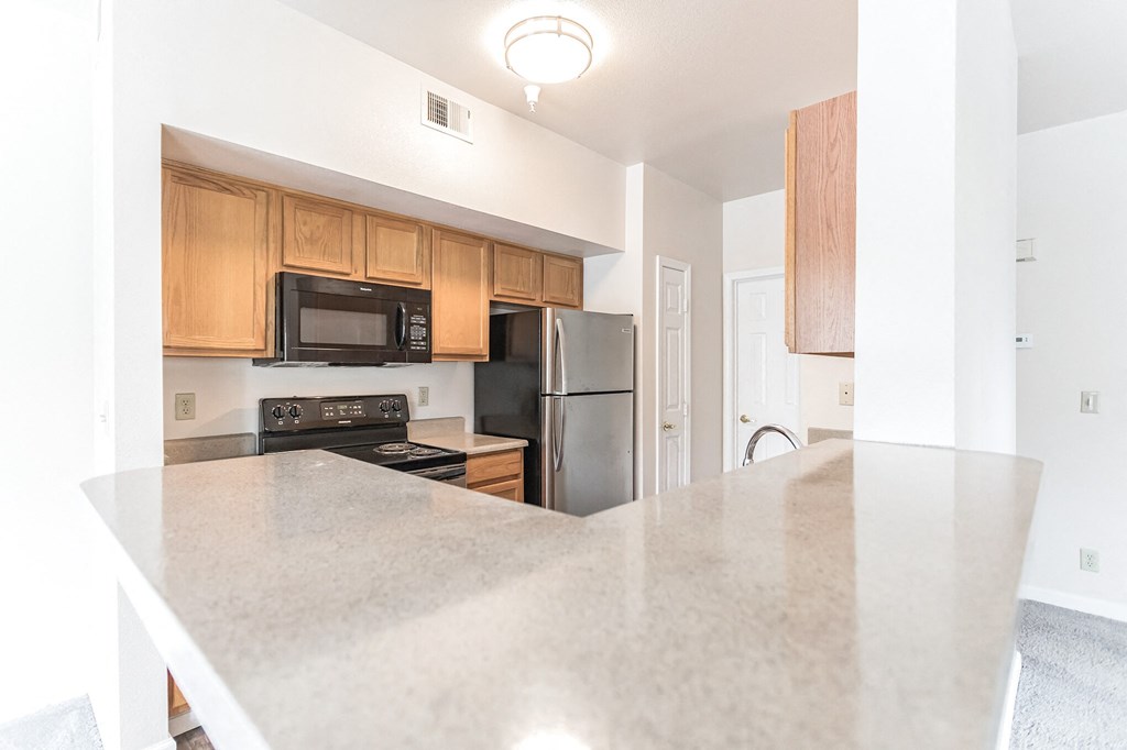 a kitchen with a large island and stainless steel appliances