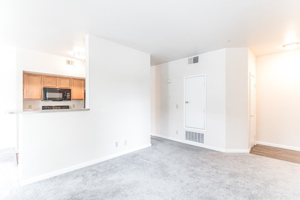 a bedroom with a medium sized bed and a window with a view of the kitchen