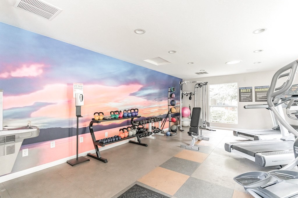 a home gym with a colorful mural on the wall at Parkway Terraces Apartments, Carson City, NV, 89706
