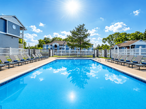 A large swimming pool with sunlight reflecting on the water.