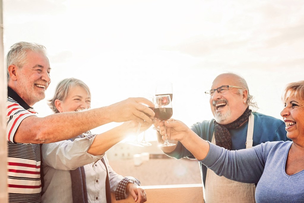 a group of people toasting with wine glasses