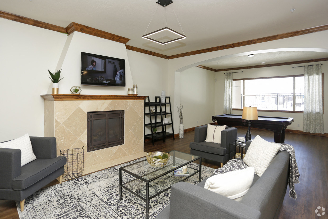 a living room with a fireplace and a television