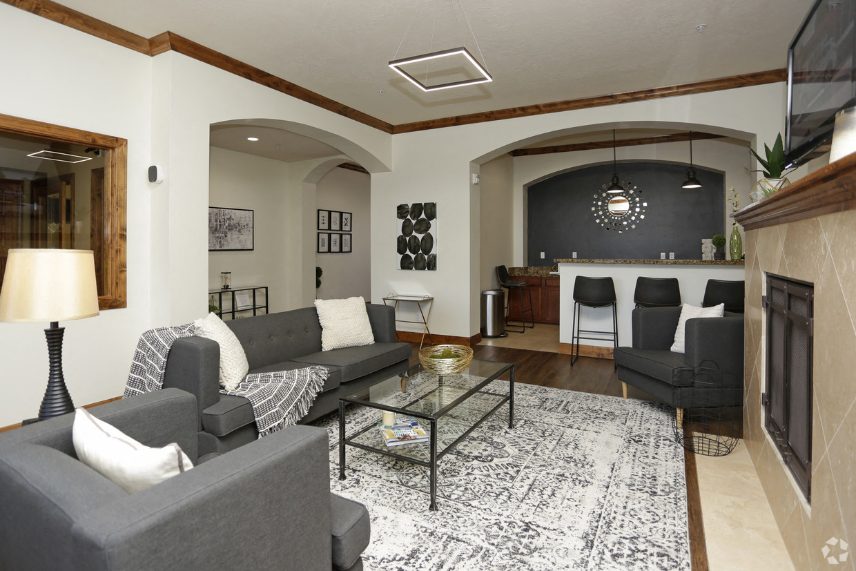 a living room with couches and a glass coffee table
